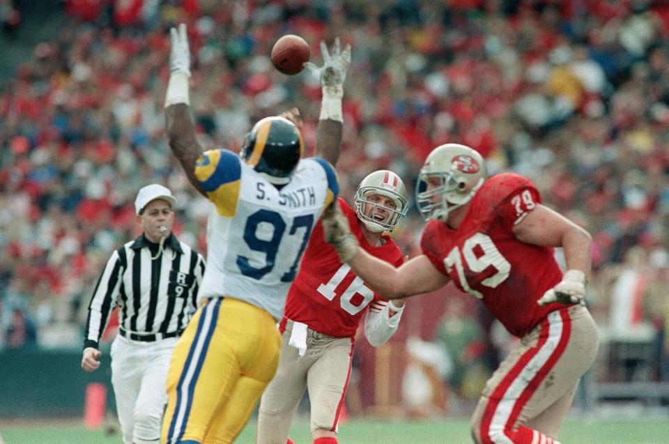 49ers quarterback Joe Montana throws a pass to Brent Jones for a touchdown over the head of Rams Sean Smith.