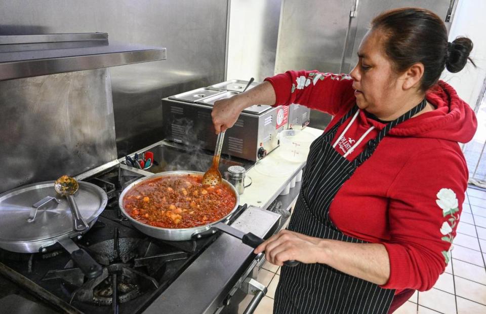 Maria Verdin cooks picadillo rojo with potatoes, one of several gordita fillings available, on the stove at Lucy’s Gorditas in Fresno on Wednesday, April 19, 2023.