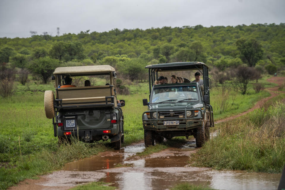Tebogo Masiu, and Smagele Twala , left, take a game drive led by Tamboti Bush Lodge owner Fred Plachesi in the Dinokeng game reserve near Hammanskraal, South Africa Sunday Dec. 5, 2021. Recent travel bans imposed on South Africa and neighboring countries as a result of the discovery of the omicron variant in southern Africa have hammered the country’s safari business, already hard hit by the pandemic. (AP Photo/Jerome Delay)