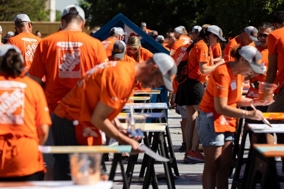 Volunteers paint and build outside at Freedom Landing in Salt Lake City on Wednesday, July 12, 2023. The Home Depot Foundation, in partnership with the Housing Authority of Salt Lake City, renovated two permanent housing facilities on Wednesday meant for homeless veterans, individuals with disabilities and the chronically homeless. | Megan Nielsen, Deseret News