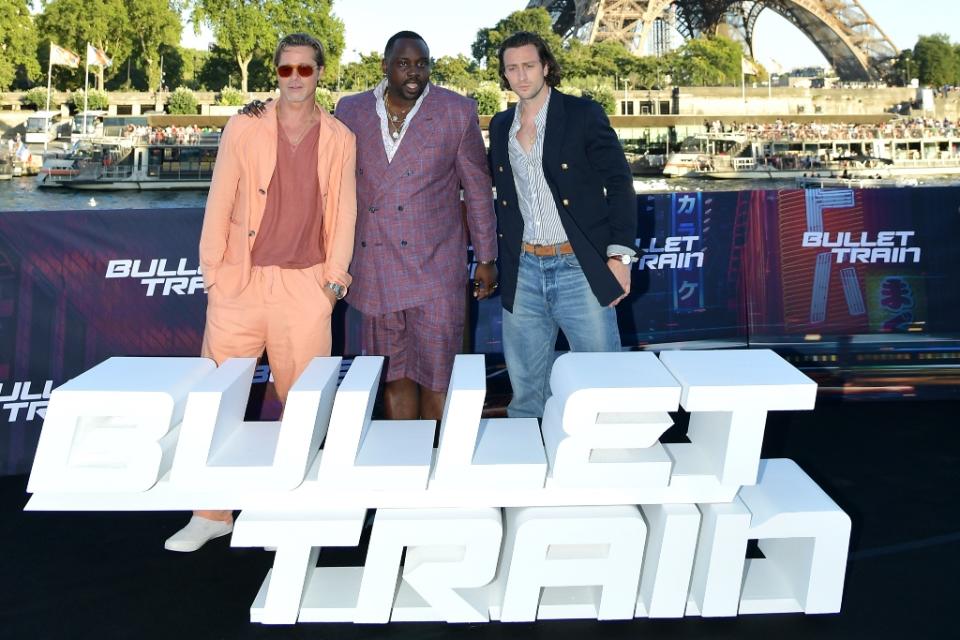 (L to R): Brad Pitt, Brian Tyree Henry and Aaron Taylor-Johnson attend the “Bullet Train” photocall at Bateau L’Excellence in Paris on July 16. - Credit: Photo by Dominique Charriau/Getty Images