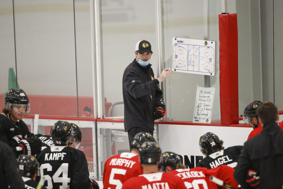 Chicago Blackhawks head coach Jeremy Collition talks to his players during hockey practice at Fifth Third Arena on Monday, July 13, 2020, in Chicago. (AP Photo/Kamil Krzaczynski)