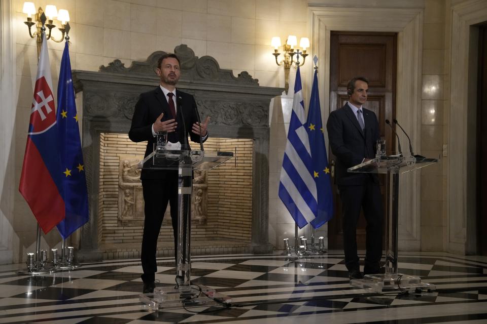 Slovakia's Prime Minister Eduard Heger, left, makes statements with his Greek counterpart Kyriakos Mitsotakis during a news conference at Maximos Mansion in Athens, Thursday, Sept. 30, 2021 (AP Photo/Thanassis Stavrakis)