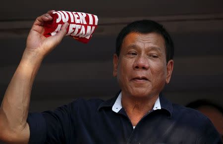 Presidential candidate Rodrigo "Digong" Duterte holds an election souvenir shirt for his supporters during election campaigning for May 2016 national elections in Malabon, Metro Manila in the Philippines April 27, 2016. REUTERS/Erik De Castro