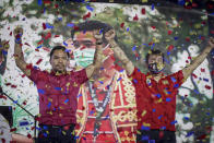In this photo provided by the Manny Pacquiao MediaComms, Senator Manny Pacquiao, left, raises his hands during a national convention of his PDP-Laban party in Quezon city, Philippines on Sunday Sept. 19, 2021. Philippine boxing icon and senator Manny Pacquiao says he will run for president in the 2022 elections. (Manny Pacquiao MediaComms via AP)