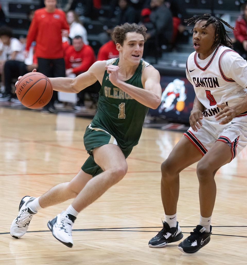 GlenOak’s Ben Davis drives past McKinley’s Keith Quincy during a boys high school basketball game at Memorial Field House on Friday, Dec. 9, 2022.