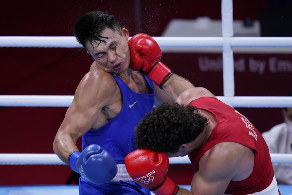 Richard Torrez Jr., of the United States, right, lands a shot to the face of Kamshybek Kunkabayev, of Kazakhstan, during their super heavy weight +91kg semifinal boxing match at the 2020 Summer Olympics, Wednesday, Aug. 4, 2021, in Tokyo, Japan. (AP Photo/Frank Franklin II)