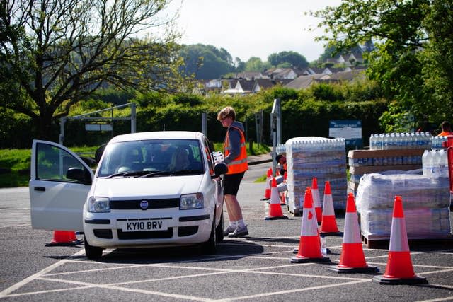 People collecting bottled water at Broadsands Car Park in Paignton.