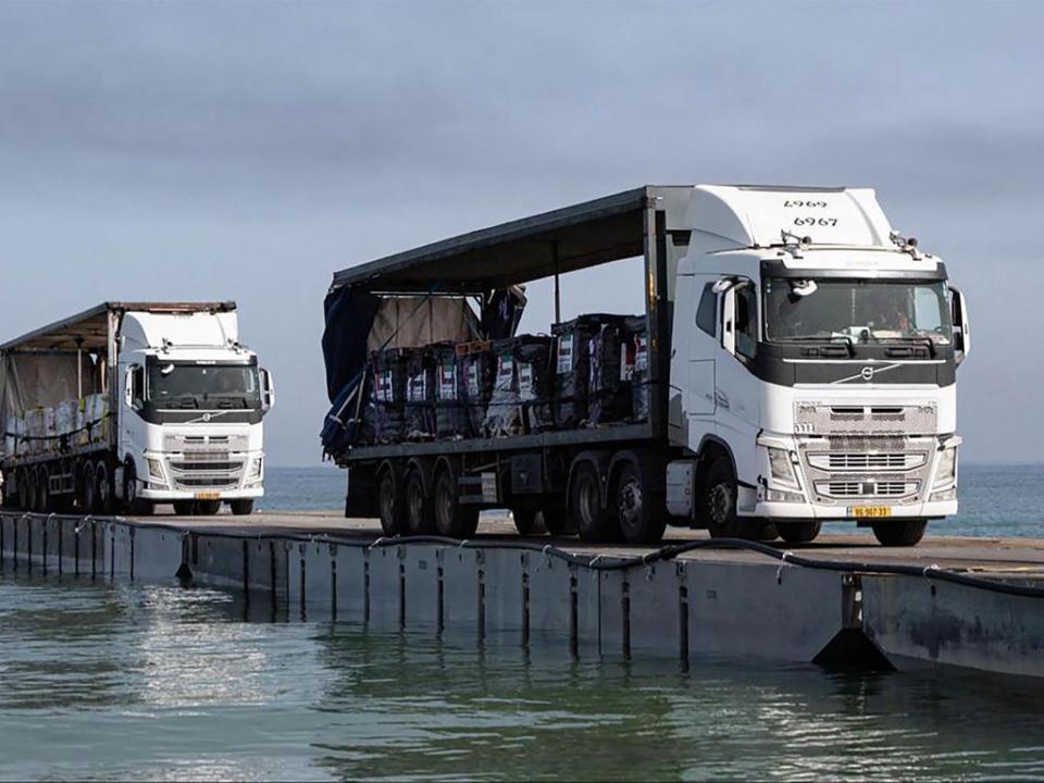 United Arab Emirati aid rolls across a US-built jetty toward Gaza on May 19. Picture: Emirates News Agency / AFP