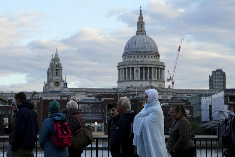 People wait in a queue to pay their respect to the late Queen Elizabeth II during the Lying-in State, in Westminster Hall, London, England, Friday, Sept. 16, 2022. The Queen will lie in state in Westminster Hall for four full days before her funeral on Monday Sept. 19. (AP Photo/Petr David Josek)