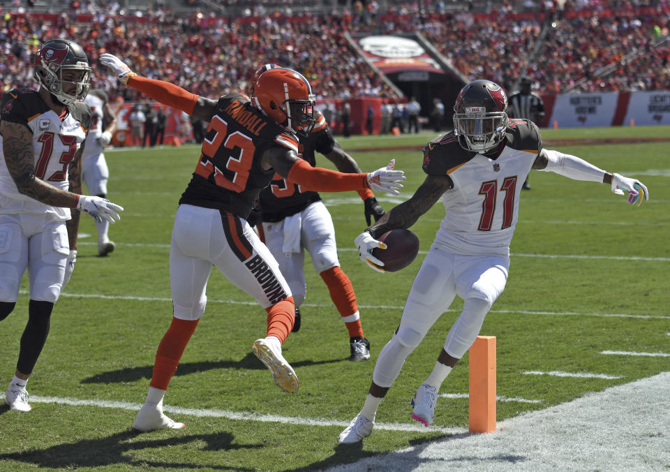 Tampa Bay Buccaneers wide receiver DeSean Jackson (11) steps around Cleveland Browns strong safety Damarious Randall (23) on an 11-yard touchdown run during the first half of an NFL football game Sunday, Oct. 21, 2018, in Tampa, Fla. (AP Photo/Jason Behnken)