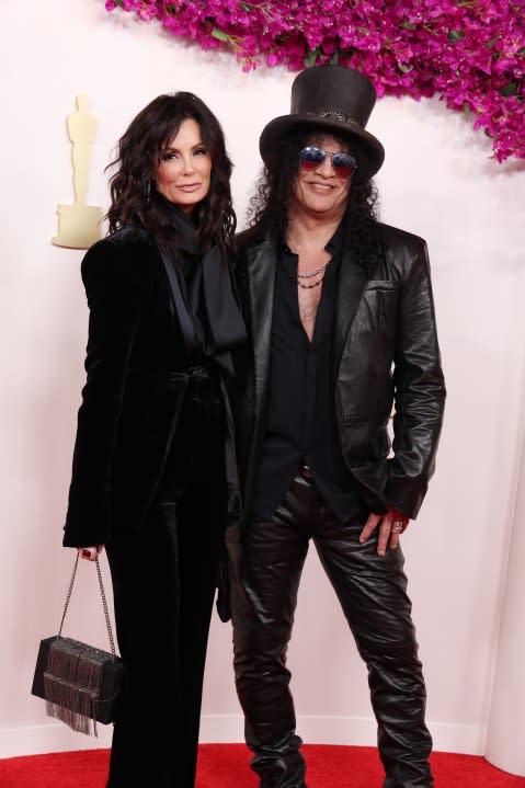 HOLLYWOOD, CALIFORNIA – MARCH 10: (L-R) Meegan Hodges and Slash attend the 96th Annual Academy Awards on March 10, 2024 in Hollywood, California. (Photo by Kevin Mazur/Getty Images)