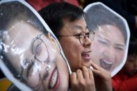 <p>A fan watches the curling women’s semi-final game between South Korea and Japan during the Pyeongchang 2018 Winter Olympic Games at the Gangneung Curling Centre in Gangneung on February 23, 2018.<br> (Photo by Wang Zhao/AFP/Getty Images) </p>