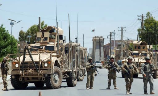 US Soldiers stop traffic leading to the governor's compound in Kandahar. Two bodyguards and two suicide attackers have been killed in a gun battle inside the the compound, an official said