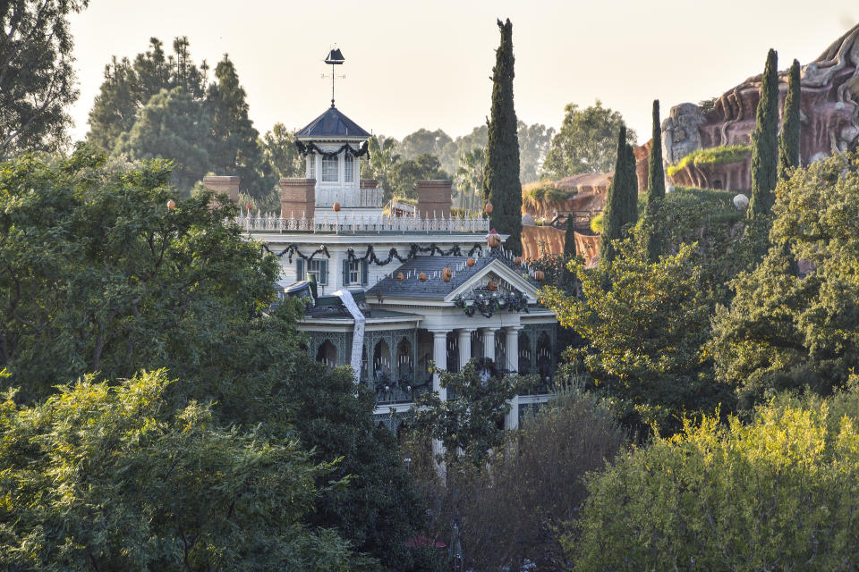 ANAHEIM, CA - DECEMBER 14: Disneyland's Haunted Mansion seen from Tarzan's Treehouse in Anaheim, California, on Thursday, Dec 14, 2017.  The Haunted Mansion. It was originally conceived to look spooky and dilapidated on the outside, but Walt Disney didn't want anything shabby in his park, so that plan was discarded. Designers first thought they would build a walk-through attraction, but later added the "doom buggies" to the design to improve traffic flow.  (Photo by Jeff Gritchen/Digital First Media/Orange County Register via Getty Images)