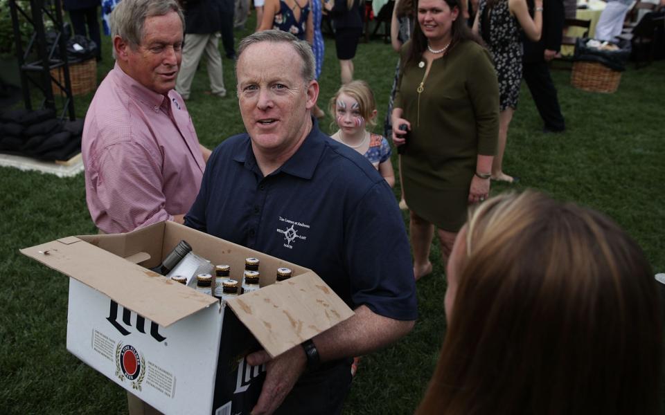 White House Press Secretary Sean Spicer (2nd L) delivers beer and wine to members of the media at a press riser - Credit: Alex Wong/Getty Images North America