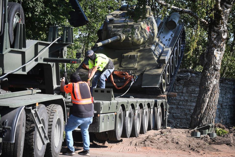 Workers remove a Soviet monument, a T-34 tank, in Narva, Estonia, on August 16, 2022.