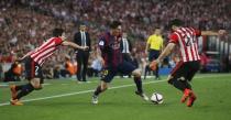 Lionel Messi goes past Benat and Mikel Balenziaga on his way to score the first goal for Barcelona. Reuters / Albert Gea