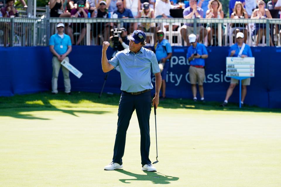 Stephen Ames celebrates after making his putt on the 18th green to win the Champions Tour Principal Charity Classic golf tournament on Sunday in Des Moines.