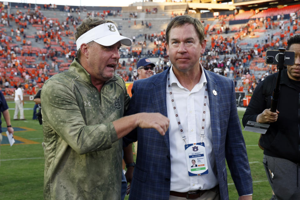 Auburn head coach Hugh Freeze, left, talks with Auburn Athletic Director John Cohen, right, after the second half an NCAA college football game against Mississippi State, Saturday, Oct. 28, 2023, in Auburn, Ala. (AP Photo/Butch Dill)