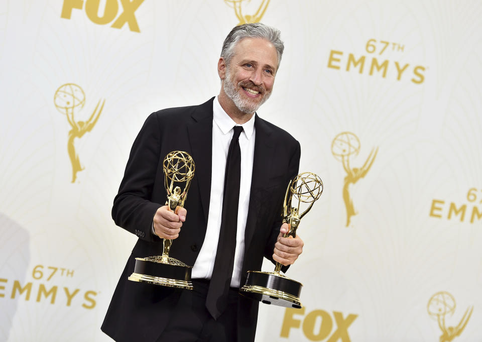 FILE - Jon Stewart, winner of the awards for outstanding writing for a variety series and outstanding variety talk show for "The Daily Show with Jon Stewart", poses in the press room at the 67th Primetime Emmy Awards on Sept. 20, 2015 in Los Angeles. Comedy Central's “The Daily Show,” launched 25 years ago this month, dedicated to skewering journalism and warning viewers about how they take in their news. (Photo by Jordan Strauss/Invision/AP, File)