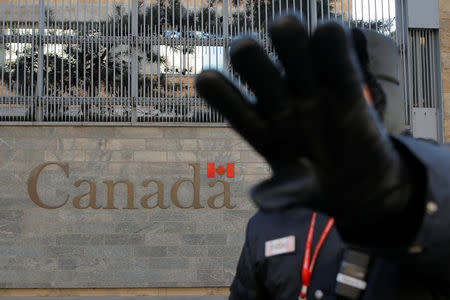 A security guard gestures at the photographer outside the Canadian embassy in Beijing, China, January 15, 2019. REUTERS/Thomas Peter