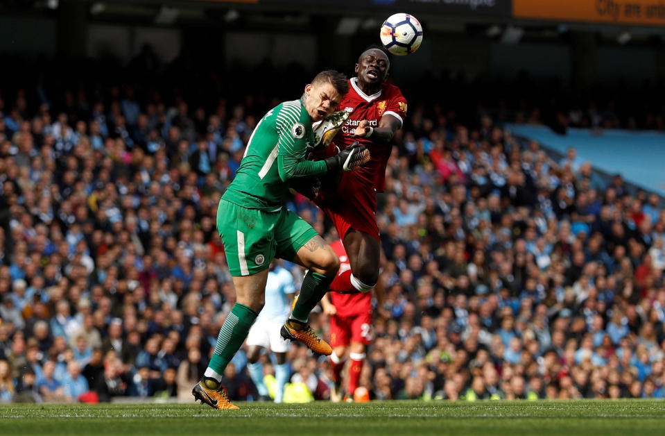 <p>Manchester City’s Ederson Moraes is fouled by Liverpool’s Sadio Mane </p>