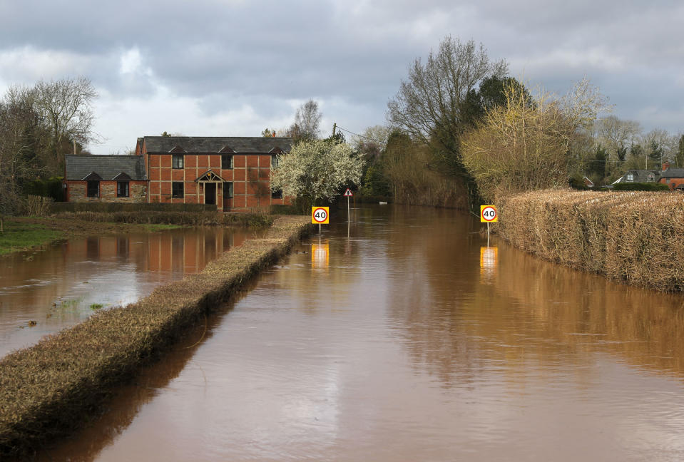 Floodwater surrounds the village of Hampton Bishop near Hereford, after the River Lugg burst its banks, Wales, Tuesday Feb. 18, 2020. Britain's Environment Agency issued severe flood warnings Monday, advising of life-threatening danger after Storm Dennis dumped weeks' worth of rain in some places. (Steve Parsons/PA via AP)