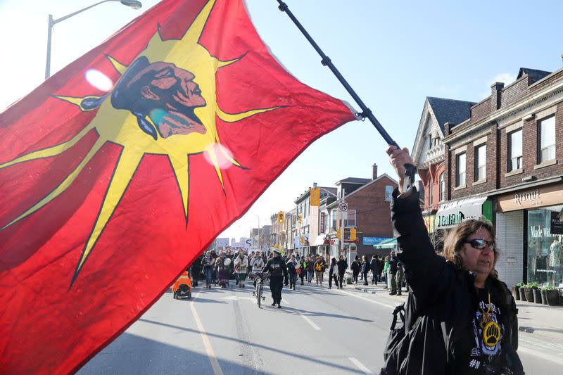 FILE PHOTO: A supporter of the indigenous Wet'suwet'en Nation, carrying a Mohawk Warrior flag, leads a march against British Columbia's Coastal GasLink pipeline, in Toronto, Ontario, Canada