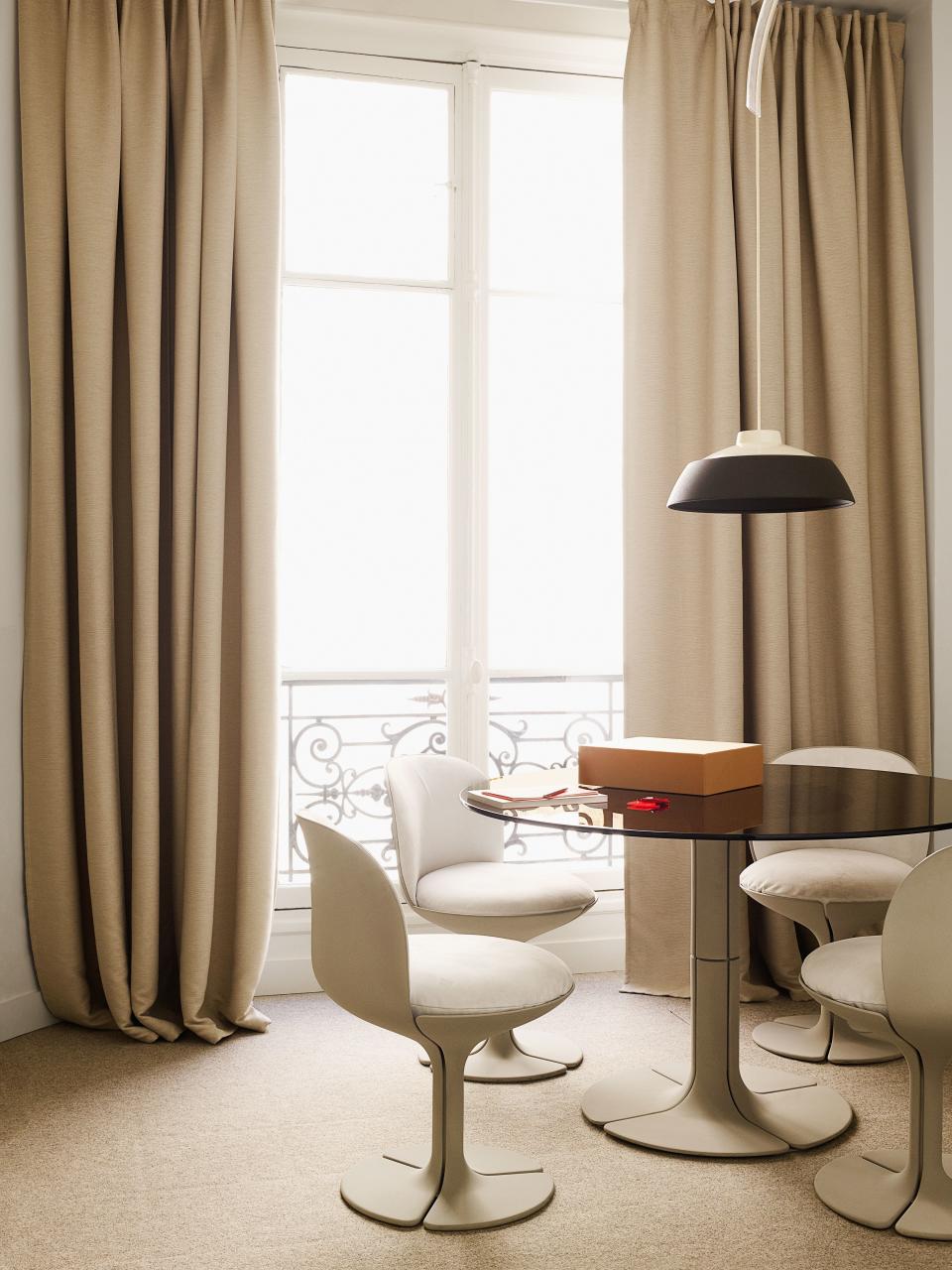 The first reeditions of Paulin's Élysée table and chairs anchor the office.