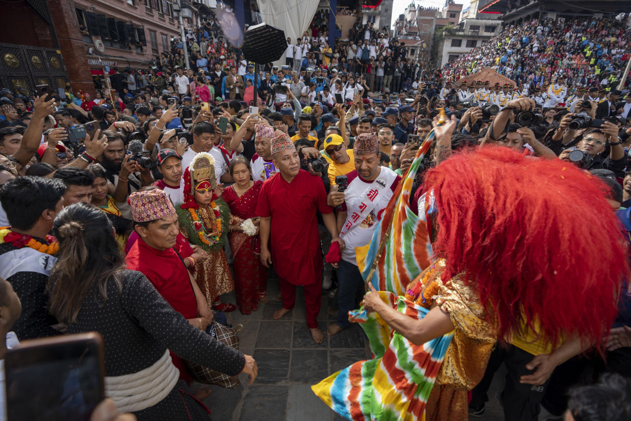 Living god Ganesh is directed towards a chariot during Indra Jatra, a festival that marks the end of the rainy season in Kathmandu, Nepal, Tuesday, Sept. 17, 2024. (AP Photo/Niranjan Shrestha)