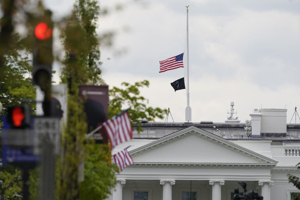 The American flag flies at half-staff over the White House in Washington, Friday, April 16, 2021. (AP Photo/Susan Walsh)