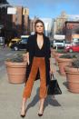 <p>The former Miss Universe hits New York Fashion Week in a black <a rel="nofollow noopener" href="http://www.express.com/clothing/women/black-drapey-crepe-trench-coat/pro/8762951/cat320021" target="_blank" data-ylk="slk:Express trench;elm:context_link;itc:0;sec:content-canvas" class="link ">Express trench</a> that's currently on sale for $89, <a rel="nofollow noopener" href="http://www.express.com/clothing/women/express-one-eleven-deep-vtoneck-thong-bodysuit/pro/6262505/cat430028" target="_blank" data-ylk="slk:Express v-neck bodysuit;elm:context_link;itc:0;sec:content-canvas" class="link ">Express v-neck bodysuit</a> ($24) and suede culottes that are available in select Express stores. </p>
