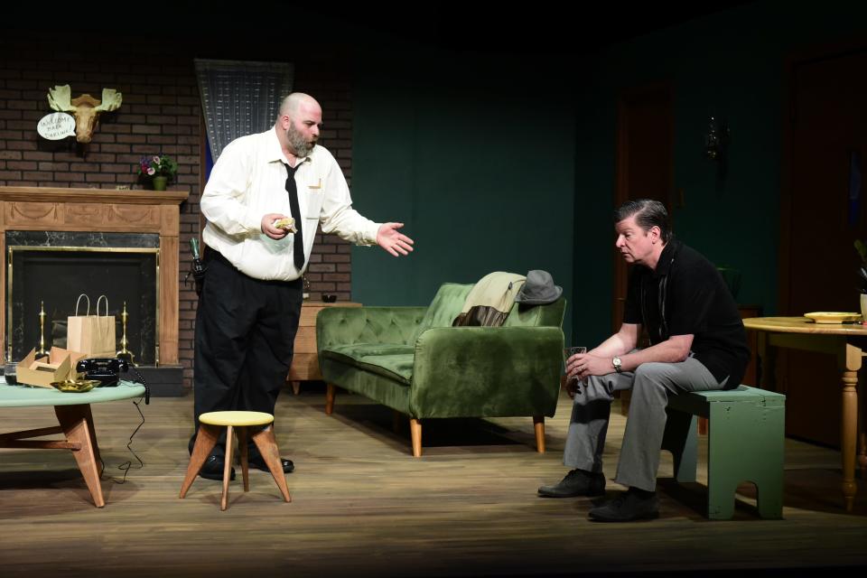 Inspector Levine, left, played by Jeffrey Dowdy of Mansfield, eats a sandwich while consoling Daniel Corban, played by Eric Gustafson of Ashland, who misplaced his wife during a performance of "Catch Me If You Can" at the Mansfield Playhouse.