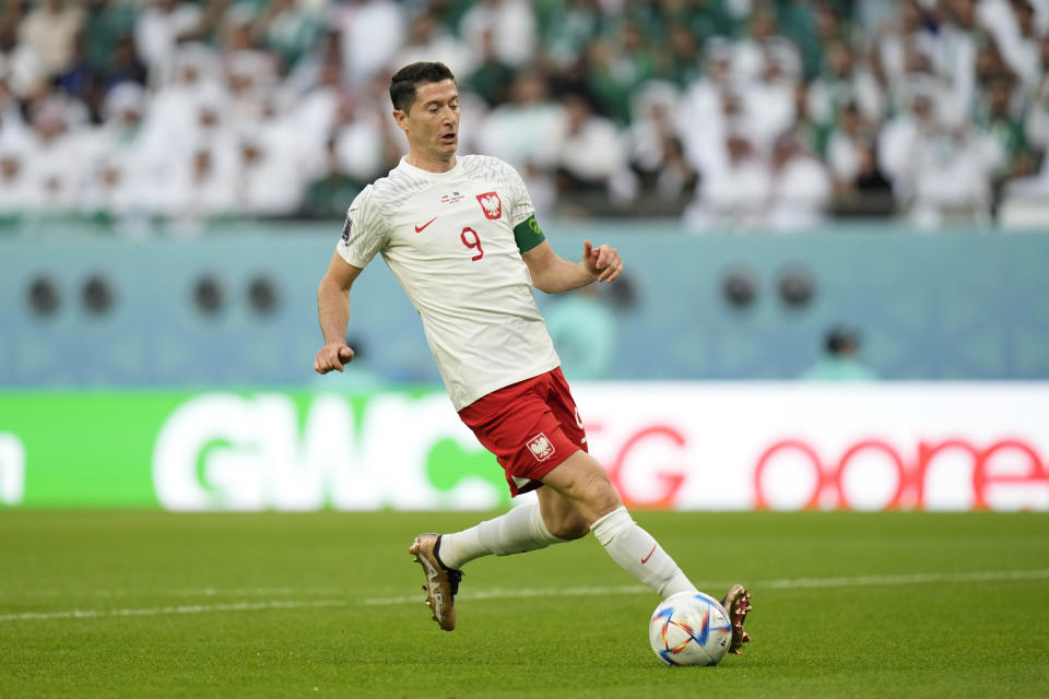 Poland's Robert Lewandowski runs with the ball during the World Cup group C soccer match between Poland and Saudi Arabia, at the Education City Stadium in Al Rayyan , Qatar, Saturday, Nov. 26, 2022. (AP Photo/Francisco Seco)