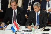 Paraguay's President Mario Abdo Benitez, right, and Paraguay's Minister of Foreign Affairs attend the Mercosur trade bloc summit at the in Montevideo, Uruguay, Tuesday, Dec. 6, 2022. (AP Photo/Matilde Campodonico)