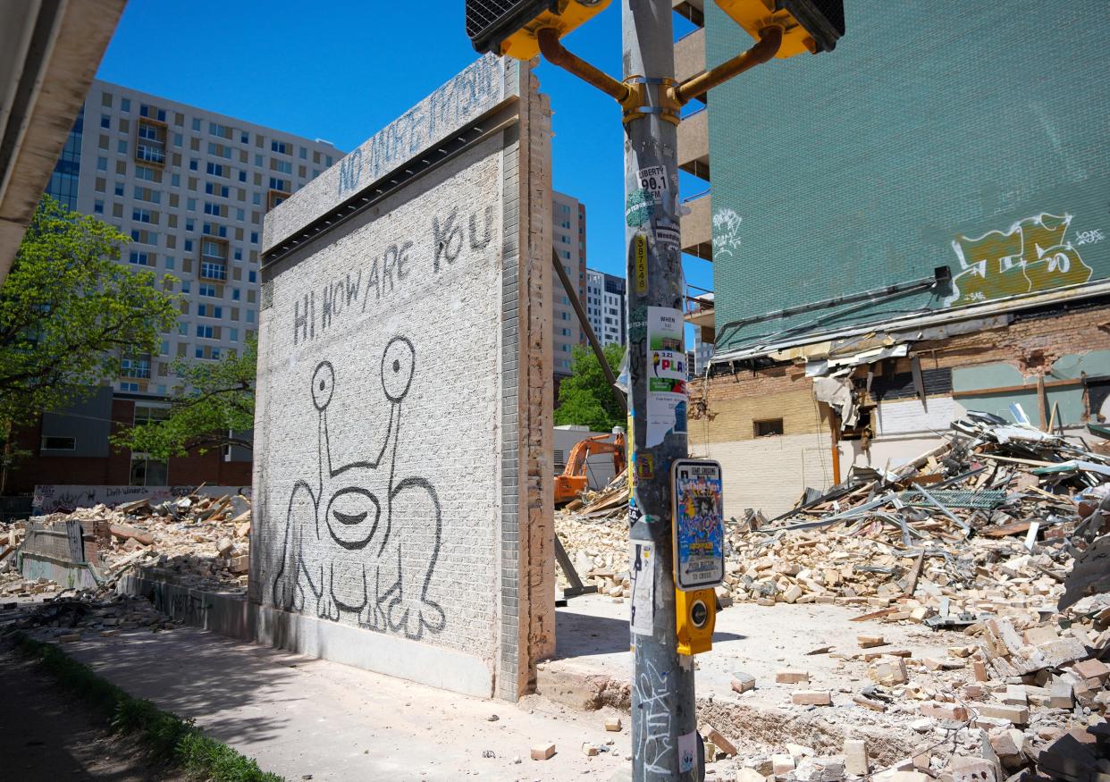 As seen last week, a portion of a wall with Daniel Johnston’s famous “Hi, How Are You” mural is all that remains of a demolished building at West 21st and Guadalupe streets.