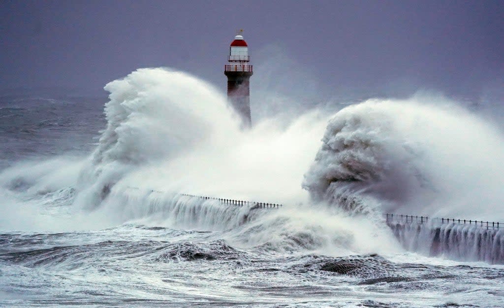 Huge waves crash the against the sea wall and Roker Lighthouse (Owen Humphreys/PA) (PA Wire)