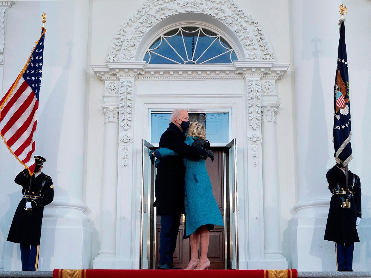 <p>US President Joe Biden hugs First Lady Jill Biden as they arrive at the White House in Washington, DC, on 20 January, 2021</p> (AFP via Getty Images)