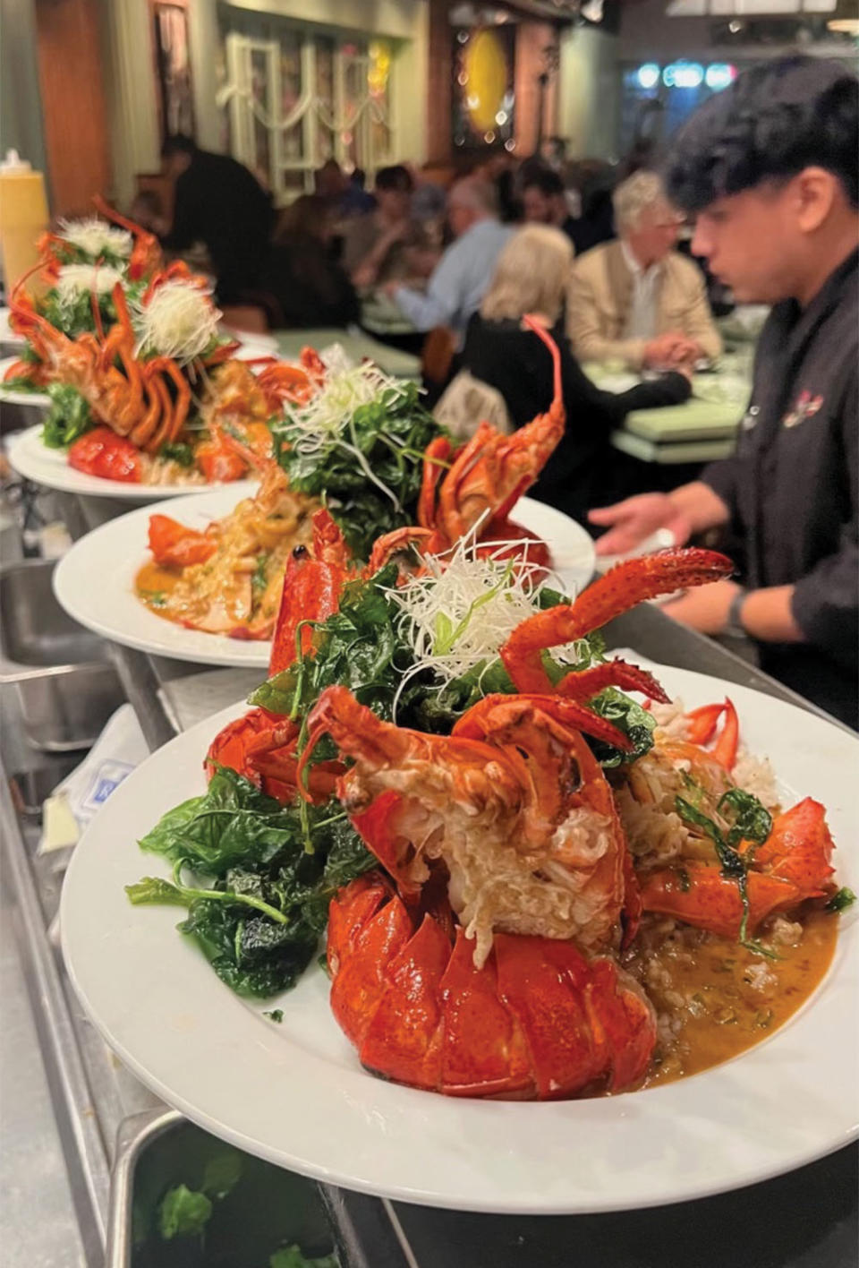 Plates of Shanghai lobster with curry sauce and crispy spinach ($75).