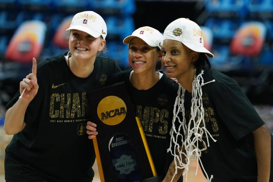 Stanford's Jana Van Gytenbeek (left), Anna Wilson (center) and Kiana Williams pose with the national championship trophy after defeating Arizona.