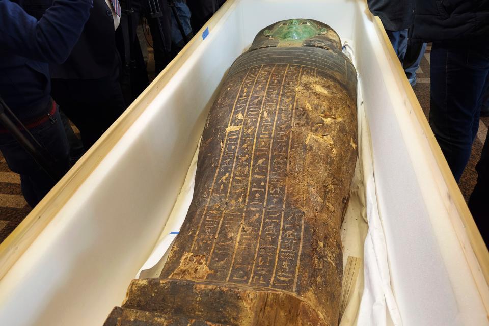 An ancient wooden sarcophagus is displayed during a handover ceremony at the foreign ministry in Cairo, Egypt, Monday, Jan. 2, 2023.