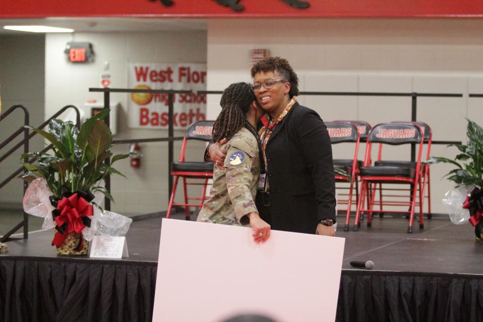 West Florida high school girls basketball alum Natalie Nicks (left) gives head coach Ieasha Stallworth-Ridgeway a hug at the surprise jersey retirement ceremony for Nicks on Friday, March 1, 2024, at West Florida High School.