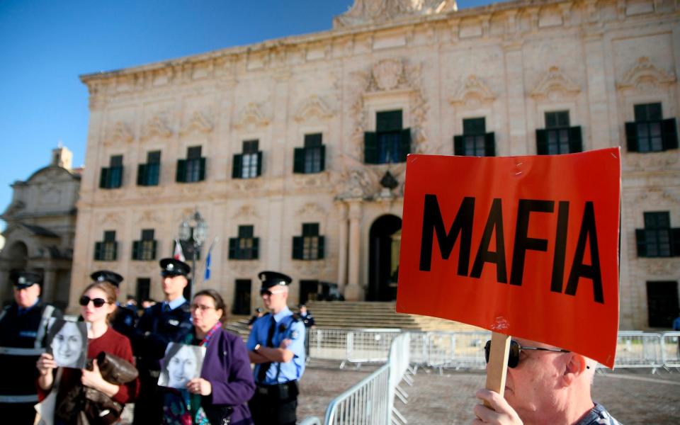 Protesters outside the prime minister's office in Valletta, Malta - AP