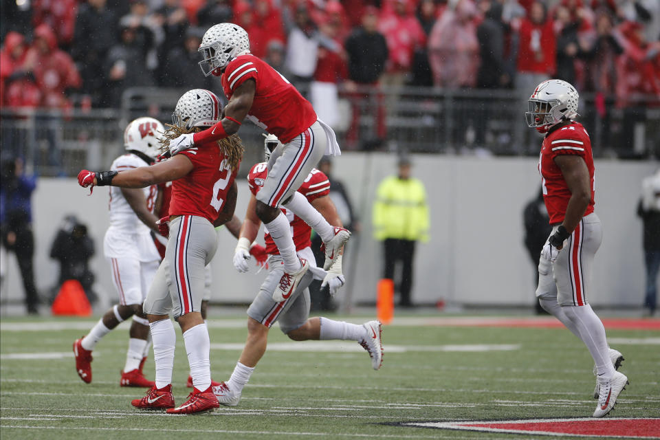 Ohio State's Chase Young, left, and Jordan Fuller celebrate a fumble recovery against Wisconsin during the second half of an NCAA college football game Saturday, Oct. 26, 2019, in Columbus, Ohio. Ohio State beat Wisconsin 38-7. (AP Photo/Jay LaPrete)