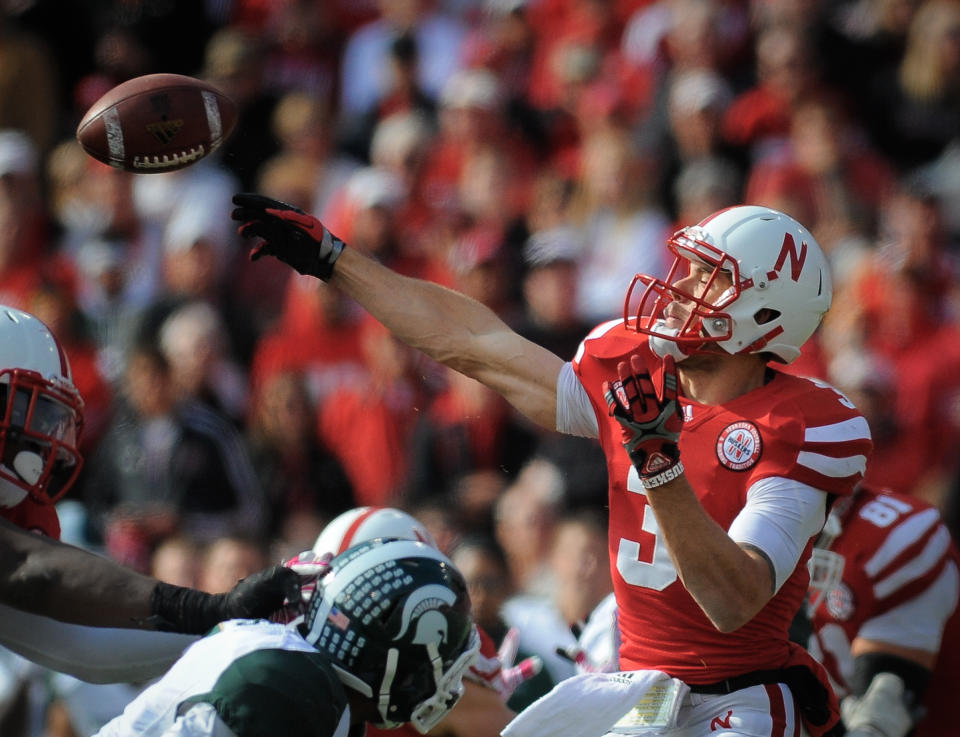 LINCOLN, NE - OCTOBER 29: Quarterback Taylor Martinez #3 of the Nebraska Cornhuskers throws downfield against the Michigan State Spartans defense during their game at Memorial Stadium October 29, 2011 in Lincoln, Nebraska. Nebraska defeated Michigan State 24-3. (Photo by Eric Francis/Getty Images)