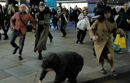 A woman stumbes as people run down Oxford Street, London, Britain November 24, 2017. REUTERS/Peter Nicholls