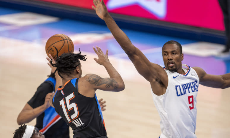 Clippers center Serge Ibaka goes for a blocked shot against the Thunder.