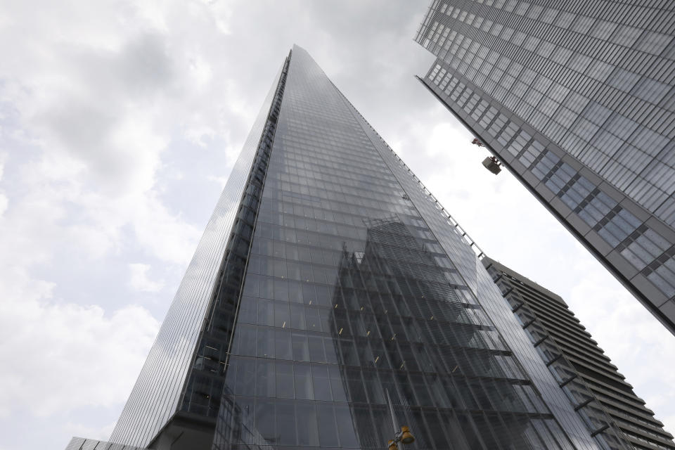 The Shard building, one of the tallest buildings in Europe, reaches up from the city of London, Monday, July, 8, 2019.  A free climber, no name released by police, scaled The Shard without safety equipment, earlier Monday. (AP Photo/Natasha Livingstone)