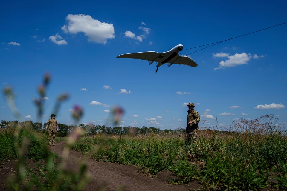 Ukrainian servicemen of the Ochi reconnaissance unit launch a Furia drone to fly over Russian positions at the frontline in Donetsk region (AP)